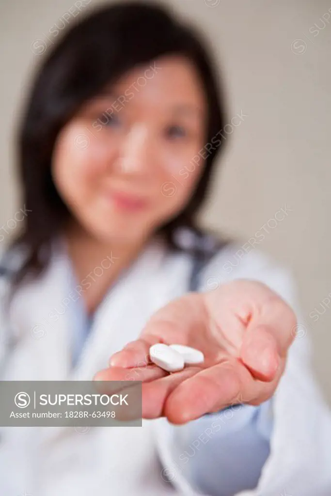 Doctor Holding Pills
