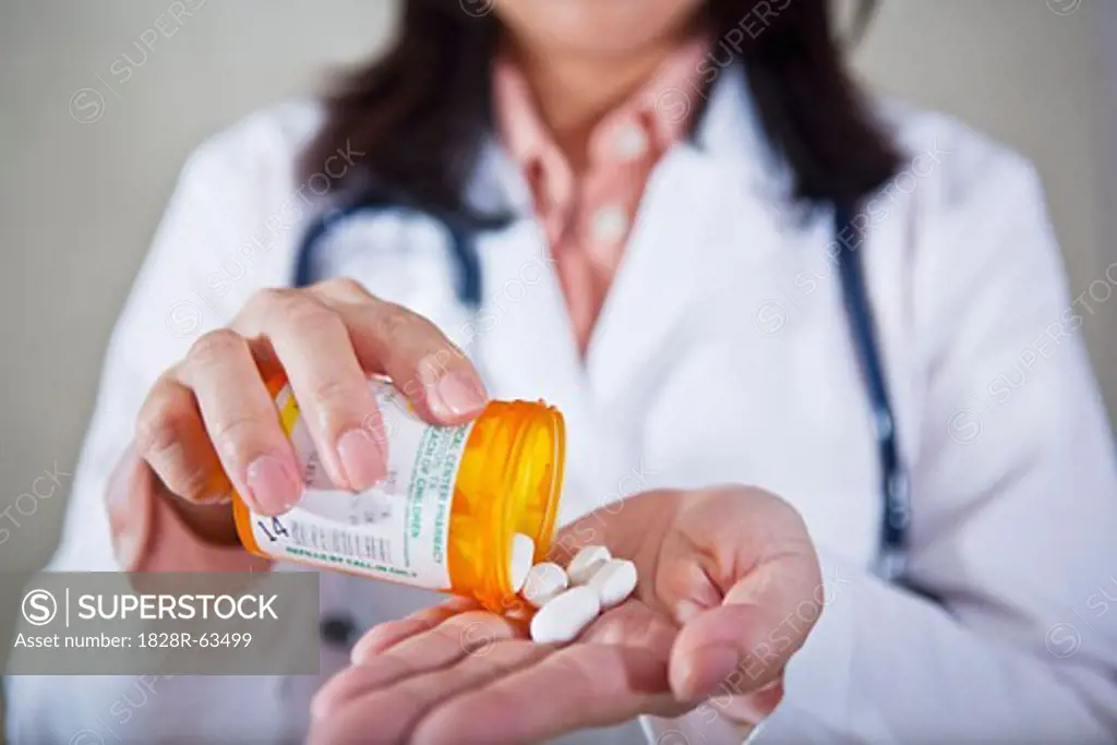 Doctor Holding Bottle of Pills