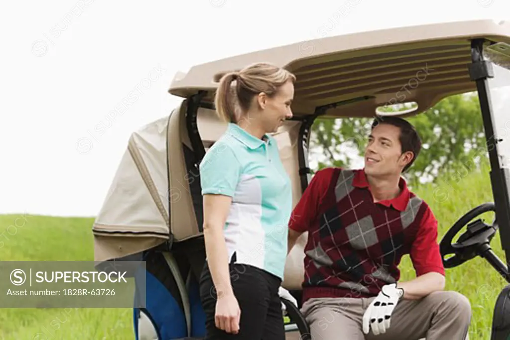 Couple with Golf Cart on Golf Course