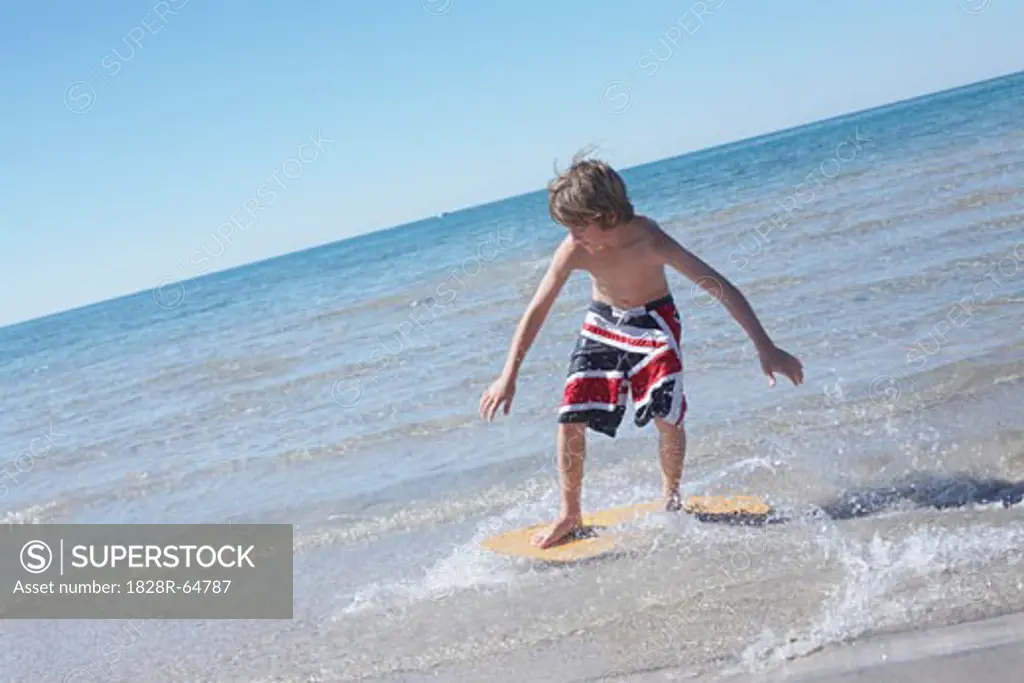Boy Skimboarding at Deanlea Beach, Elmvale, Ontario, Canada