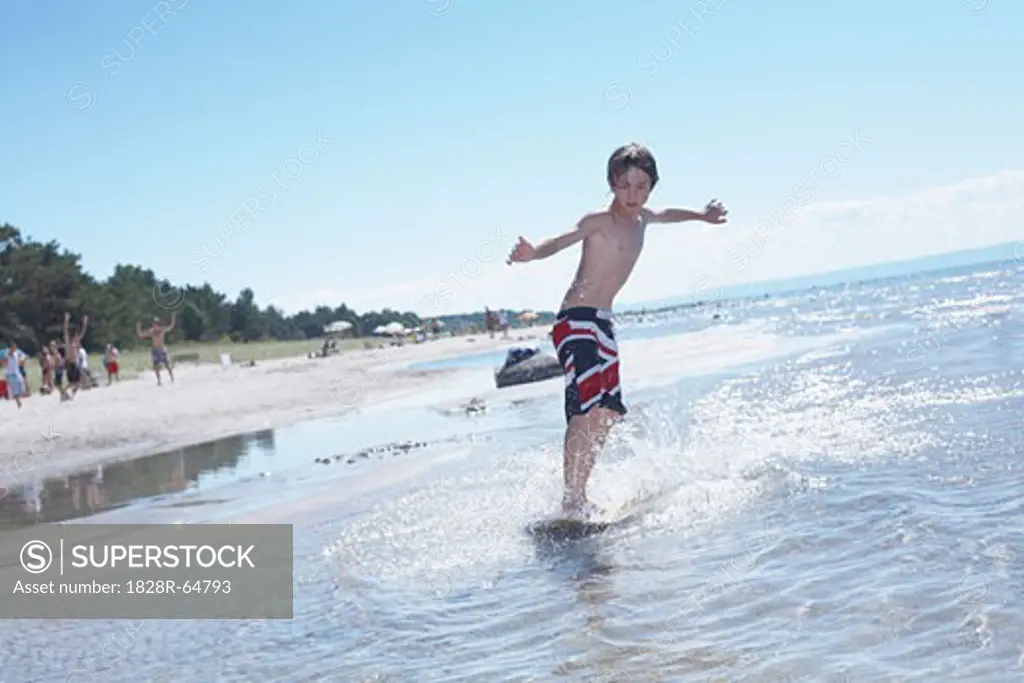 Boy Skimboarding at Deanlea Beach, Elmvale, Ontario, Canada