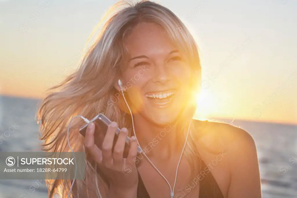 Woman on the Beach Listening to MP3 Player