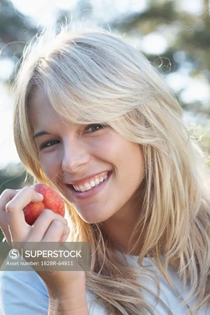 Woman Eating a Peach