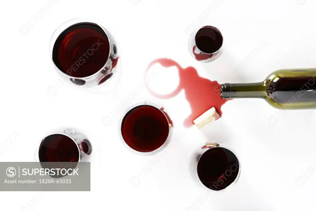 Glasses of Red Wine with Spilled Bottle