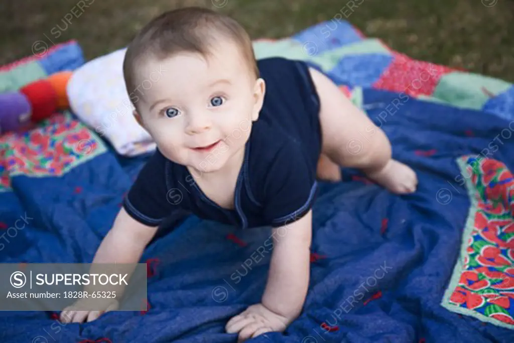 Baby Playing on Blanket Outside