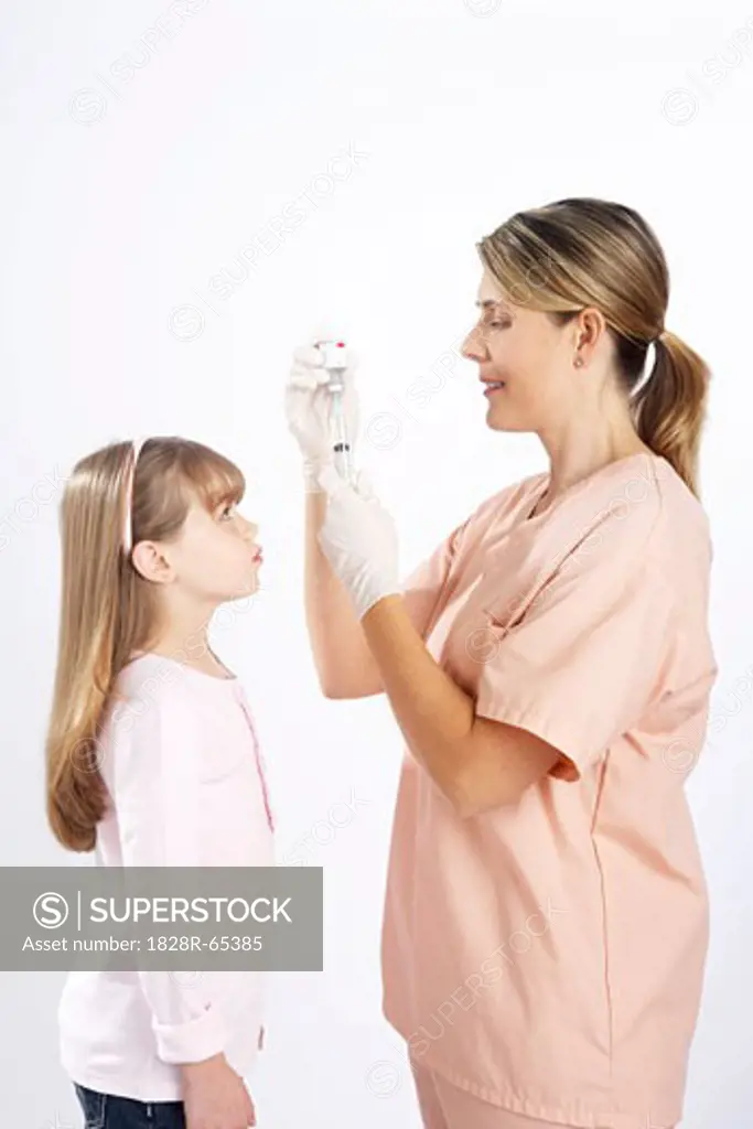 Little Girl Watching Nurse Prepare a Needle