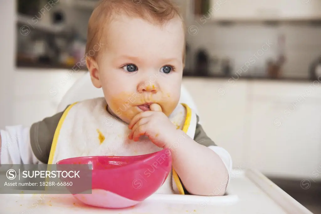 Baby in High Chair Eating