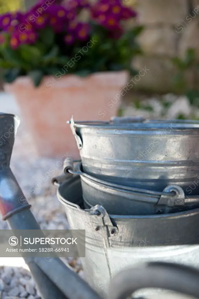 Watering Can and Stack of Metal Buckets