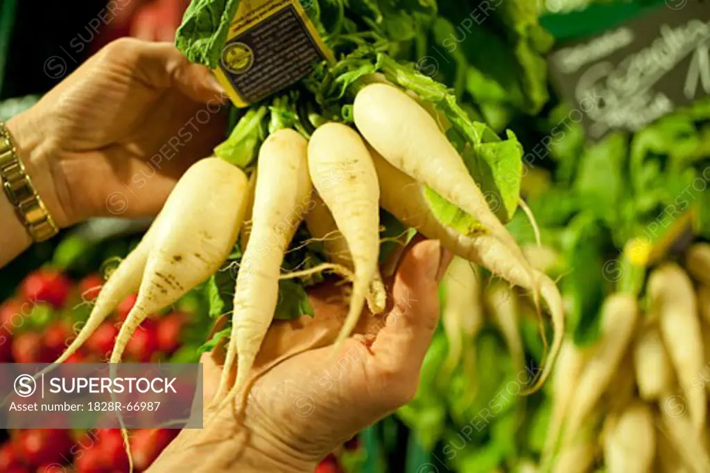 Person Holding Vegetables at Market