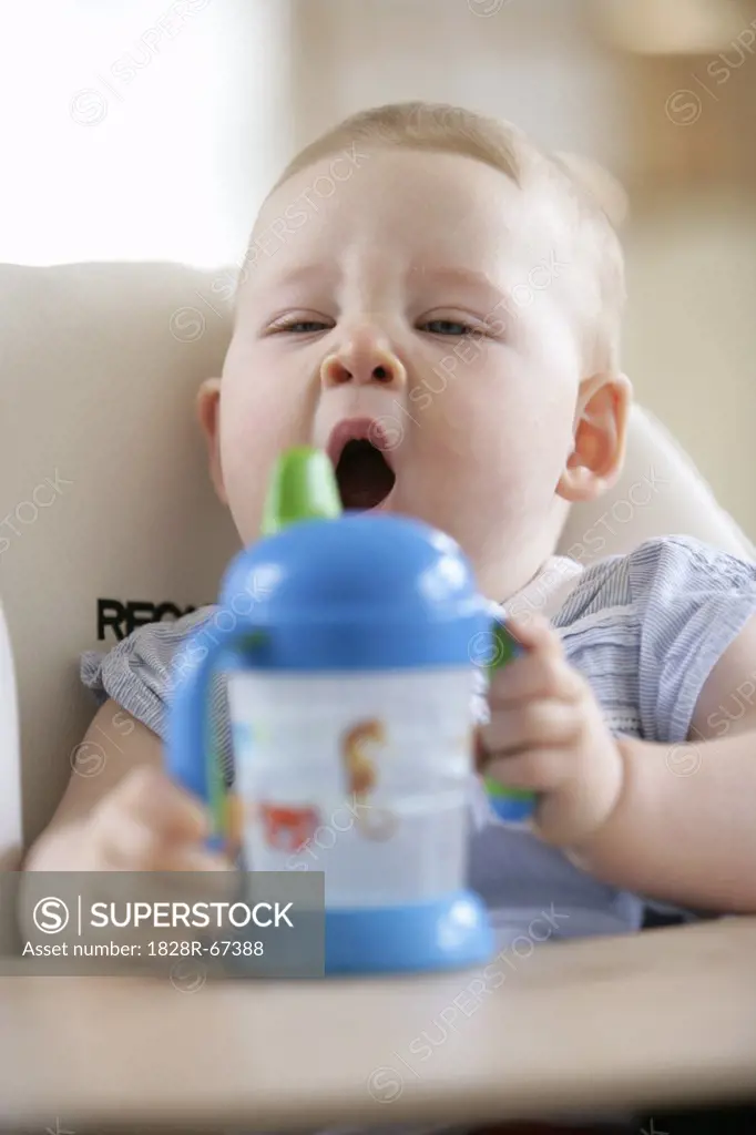 Baby Girl in High Chair Yawning