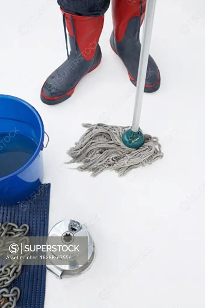 Close-up of Person Wearing Rubber Boots and Mopping Boat Deck