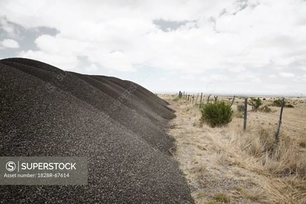 Piles of Gravel by Fence, Texas, USA