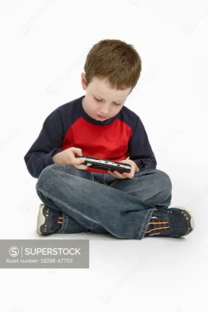 Boy Playing Handheld Video Game