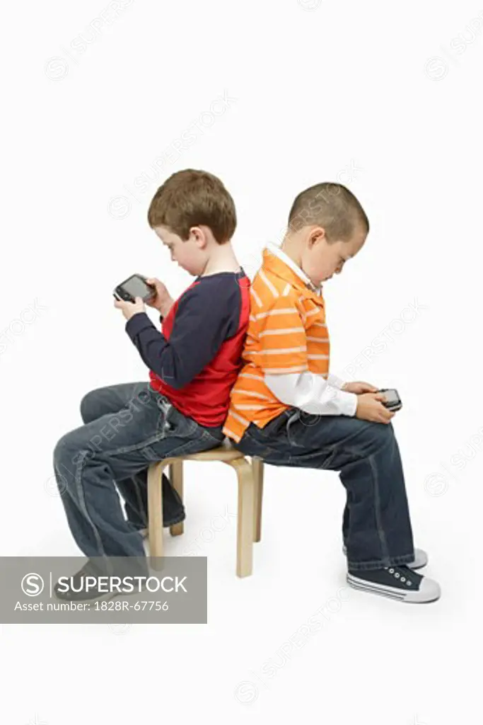 Boys with Handheld Video Games Sitting Back to Back