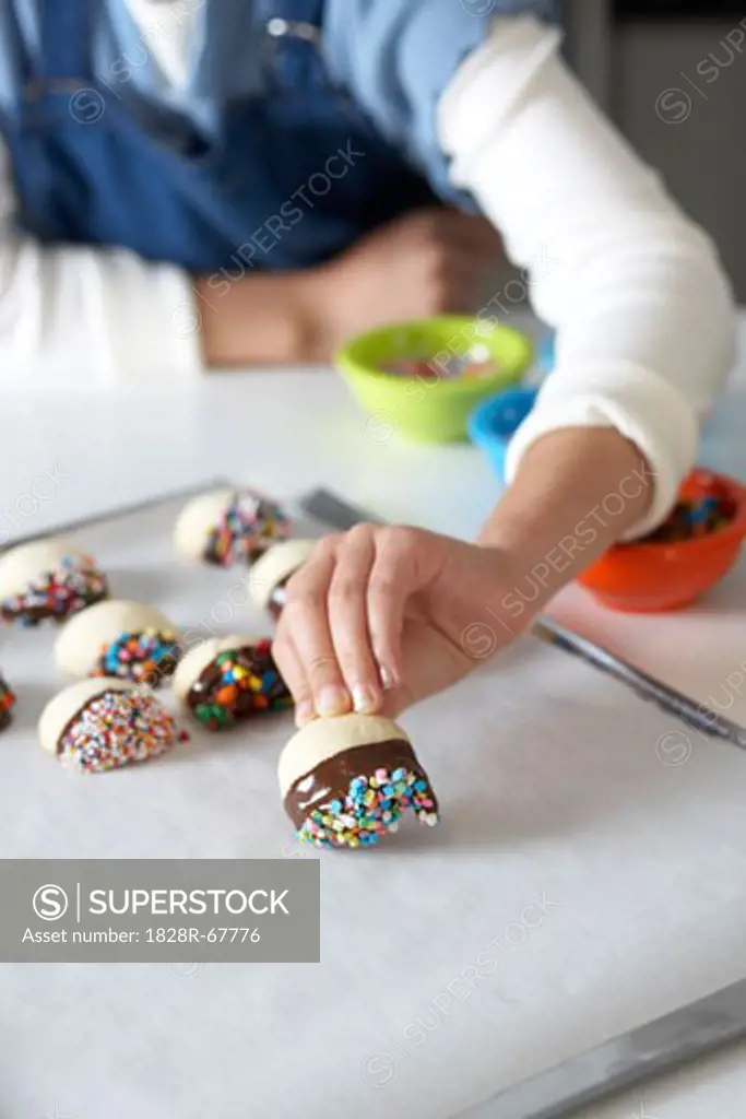 Woman Making Chocolate Dipped Shortbread with Sprinkles