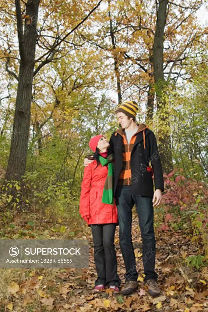 Couple Walking in Forest in Autumn
