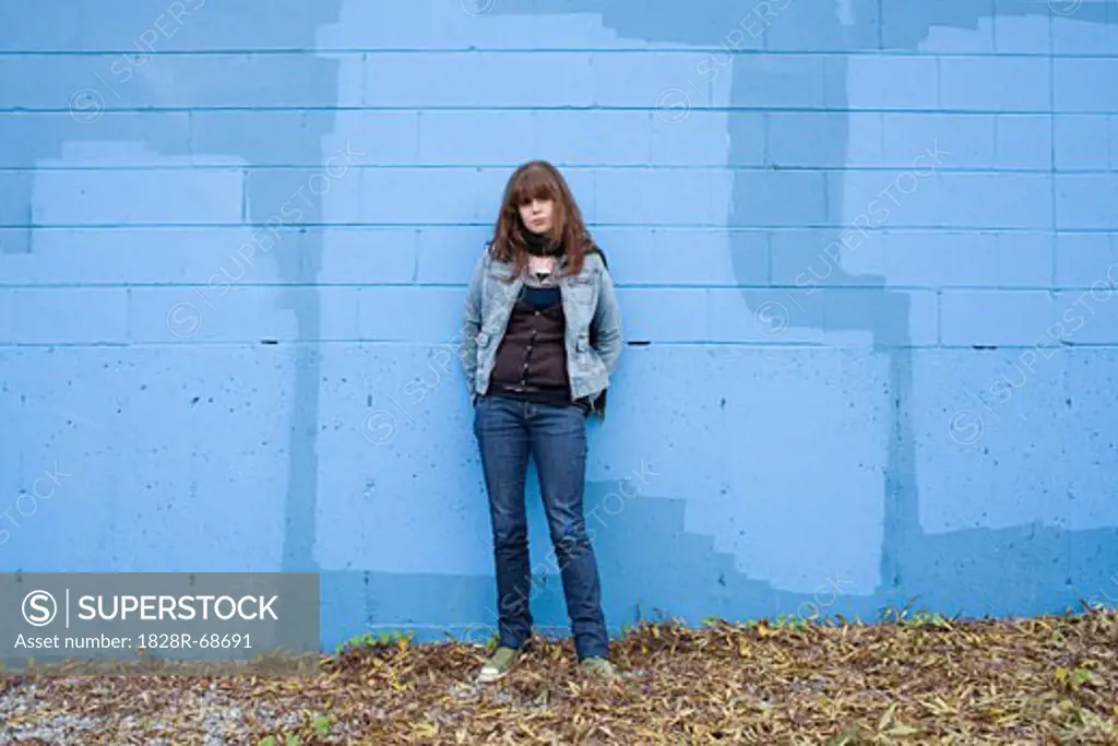 Woman Standing by Blue Wall, Vancouver, British Columbia, Canada