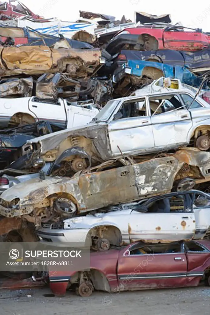 Old Cars Stacked up in Auto Wreckage Yard