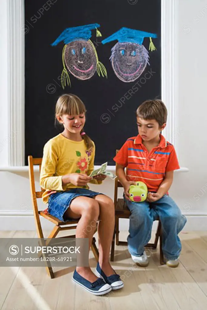 Boy and Girl Counting Money for College Fund