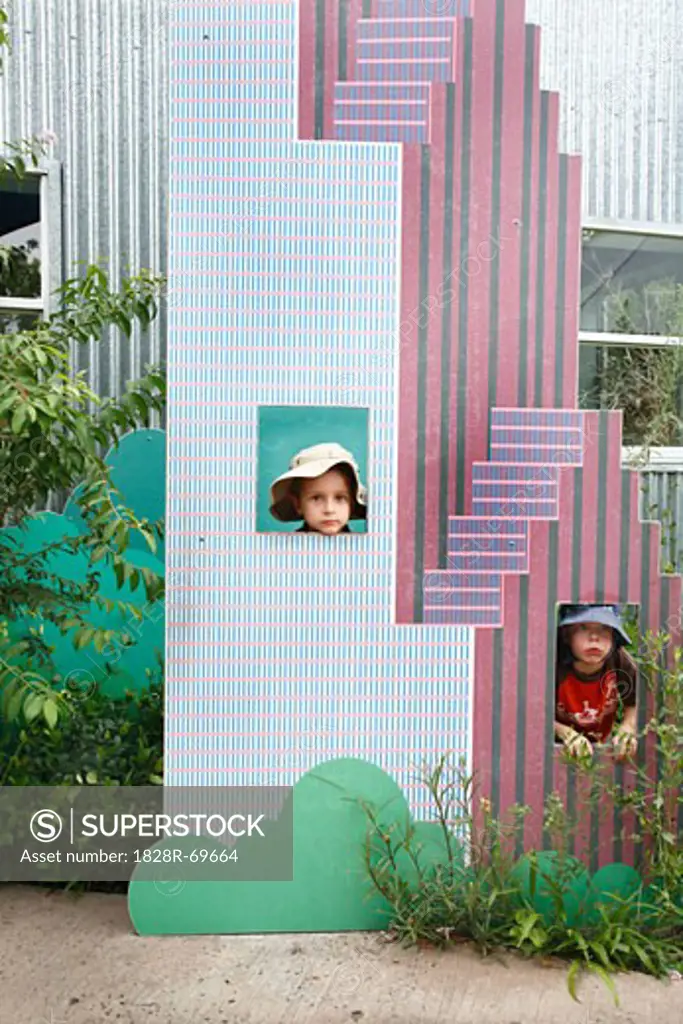 Little Boys Playing in Cardboard Skyscraper