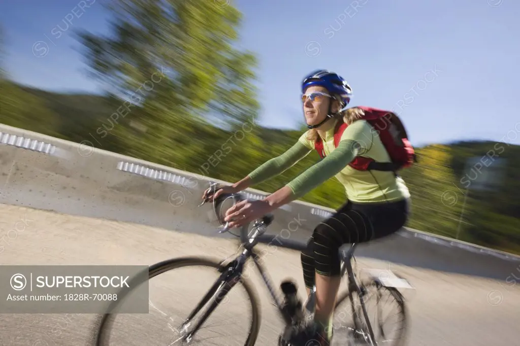 Woman Riding Bicycle, Steamboat Springs, Routt County, Colorado, USA