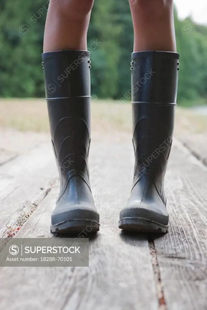 Close-up of Woman Wearing Rubber Boots on Dock, Near Portland, Oregon, USA