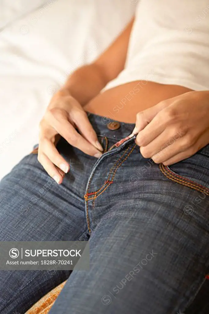Woman Zipping Up Pants