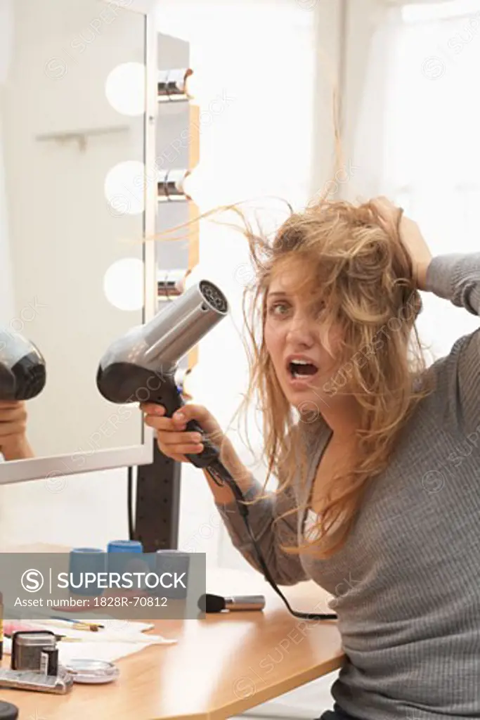 Woman using Hair Dryer