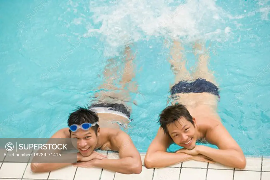Male Couple Leaning on Edge of Swimming Pool