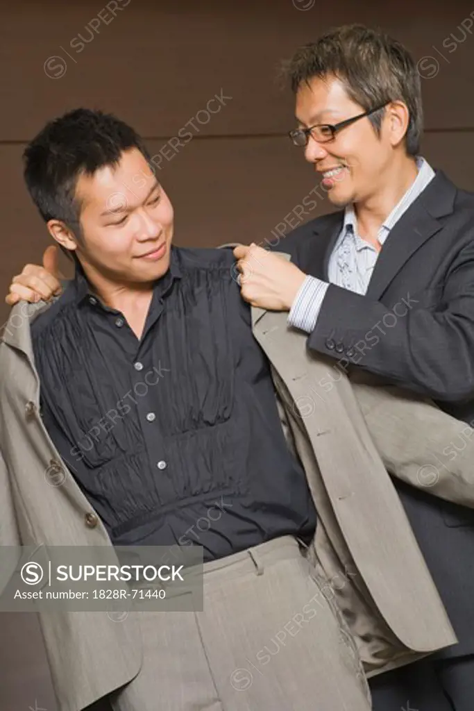 Man Helping His Partner With His Coat
