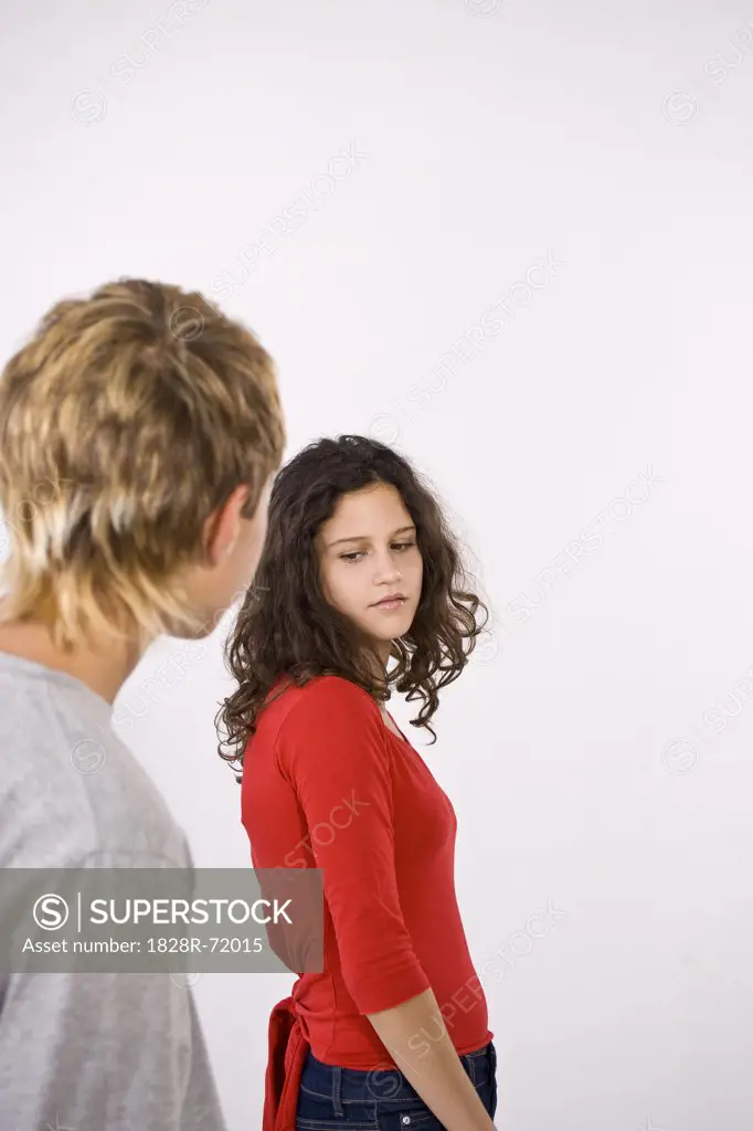 Teenage Girl Looking Disdainfully at Teenage Boy