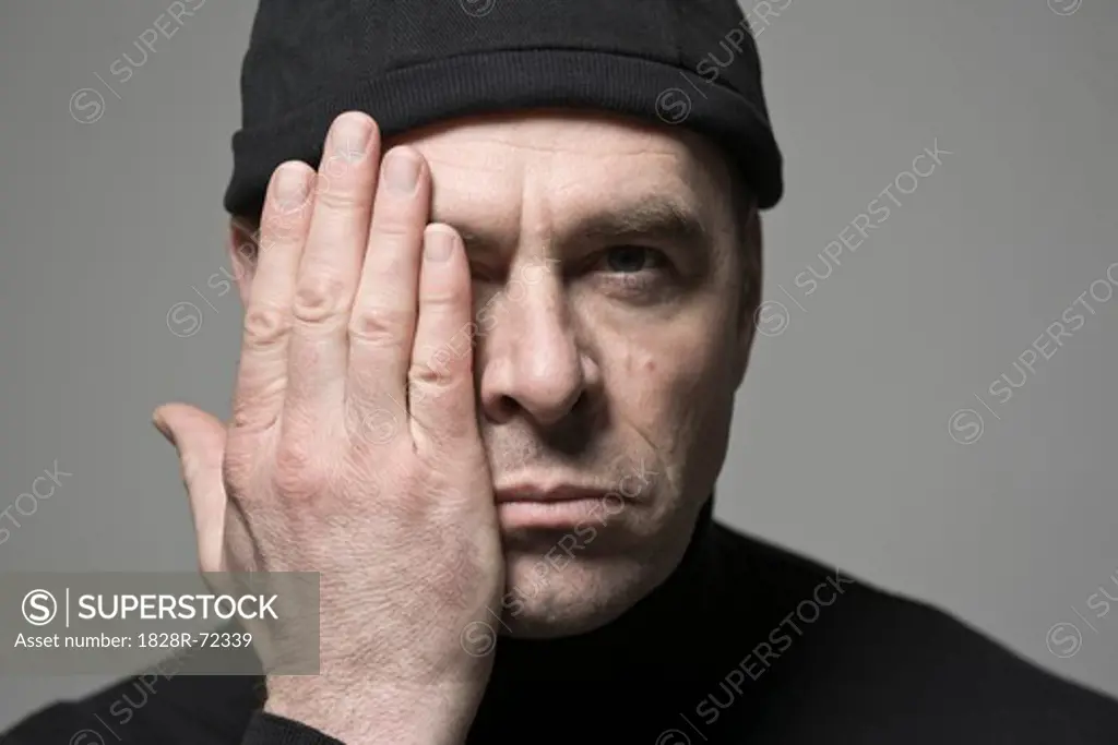 Man Covering One Side of His Face