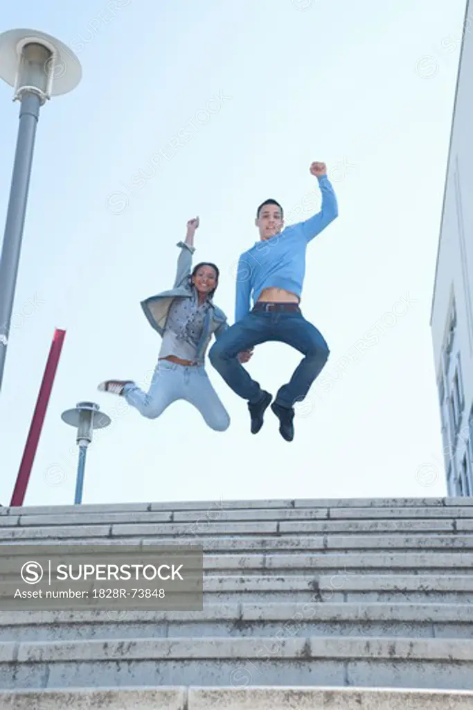 Couple Jumping in Air
