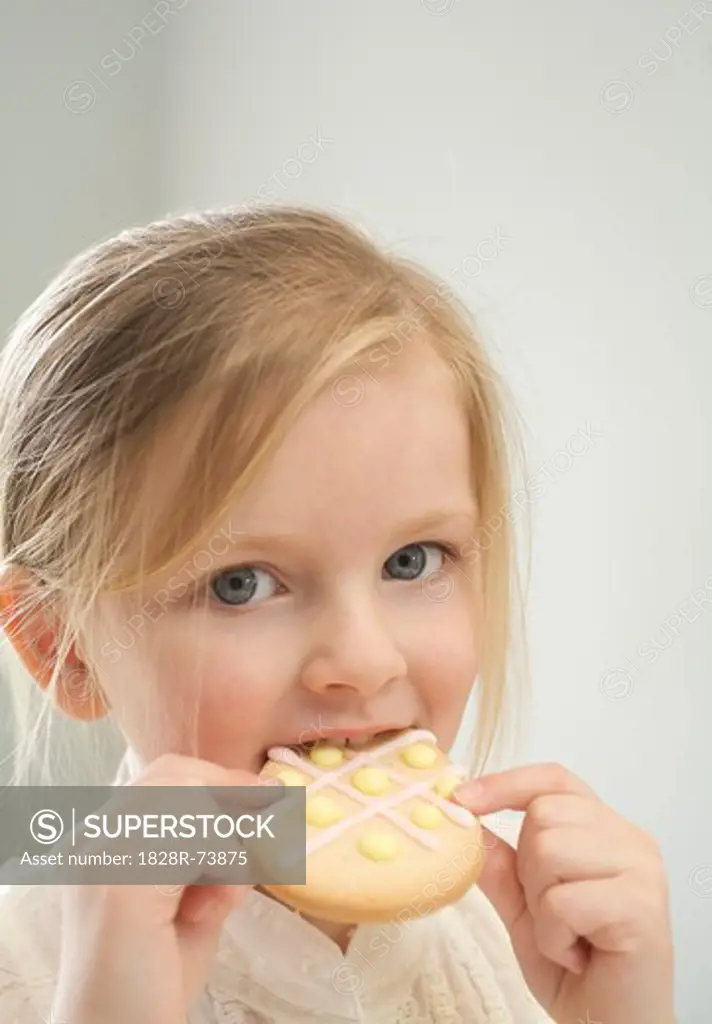 Little Girl Eating an Easter Cookie