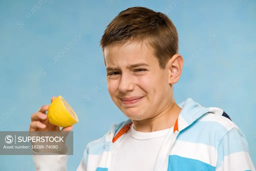 Boy Eating a Lemon