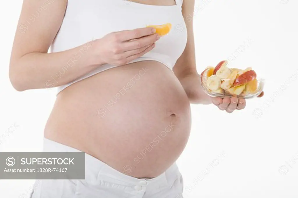 Pregnant Woman Eating Fruit