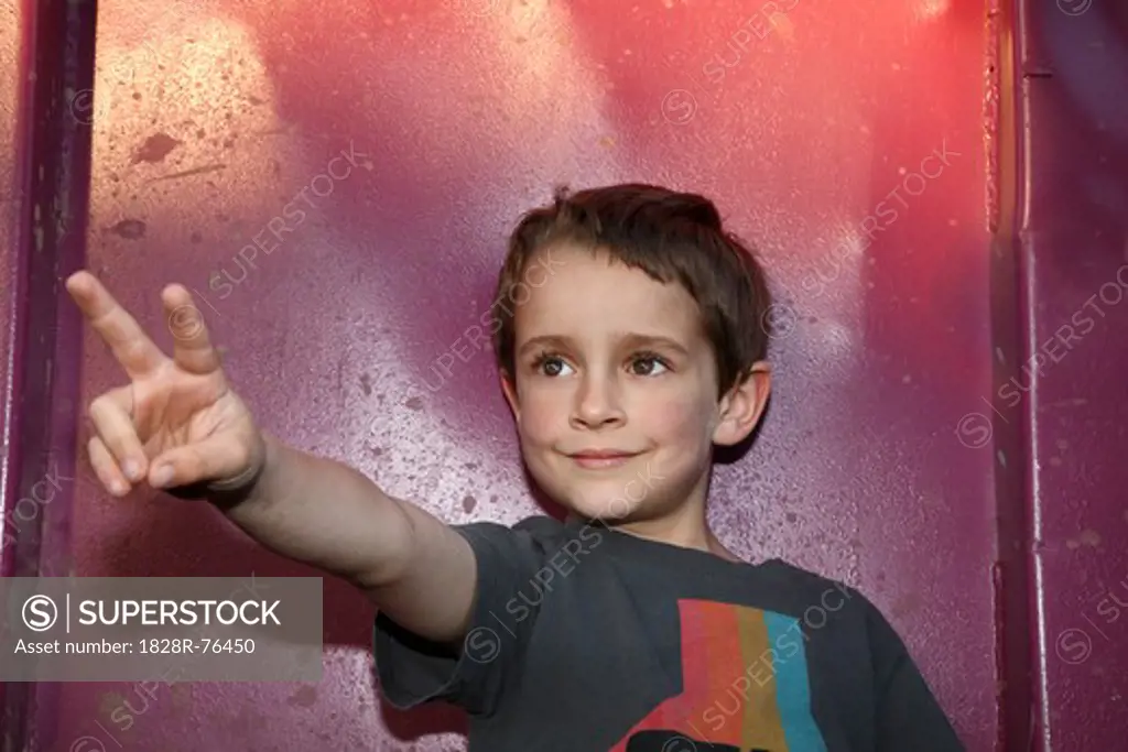 Portrait of Boy making Hand Gesture