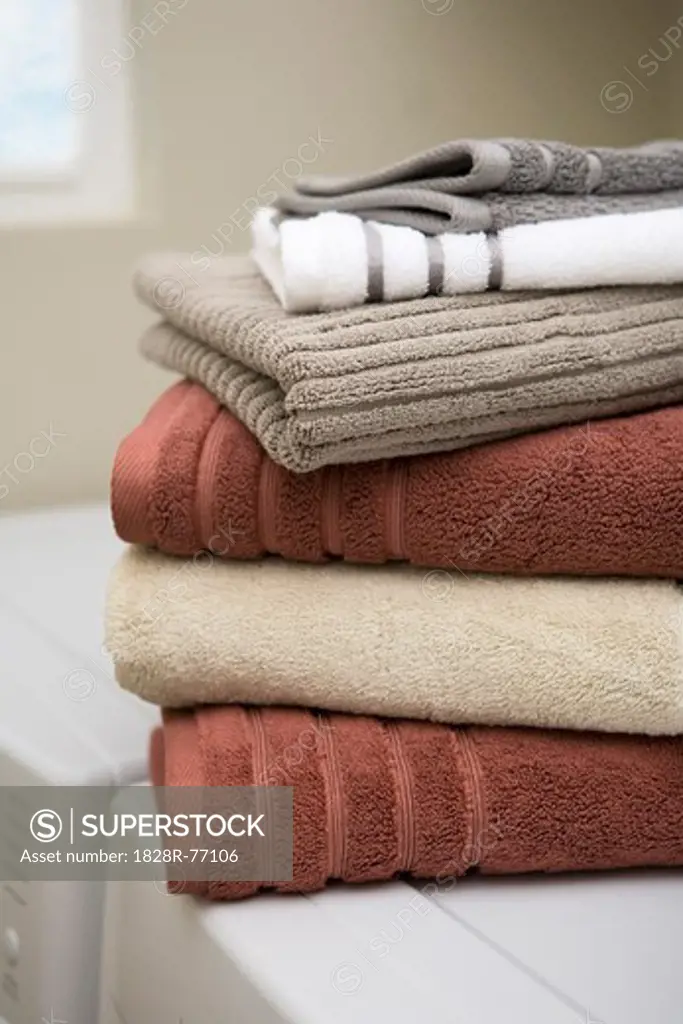 Stack of Clean Towels on Washer and Dryer