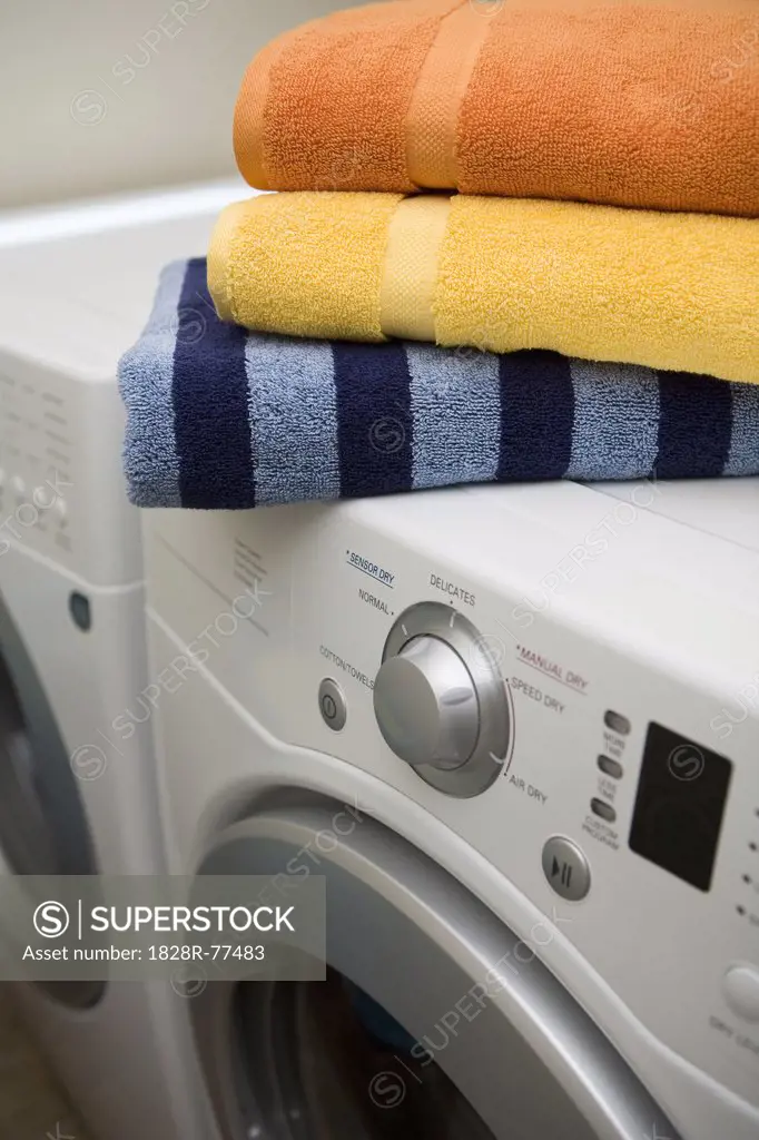 stack of towels on top of washer and dryer