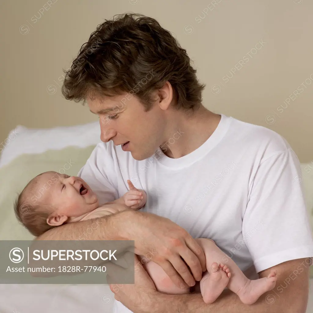 Crying Baby Held by Father