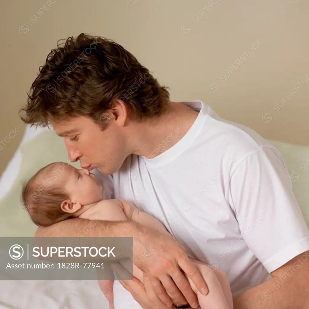 Father Kissing Sleeping Baby