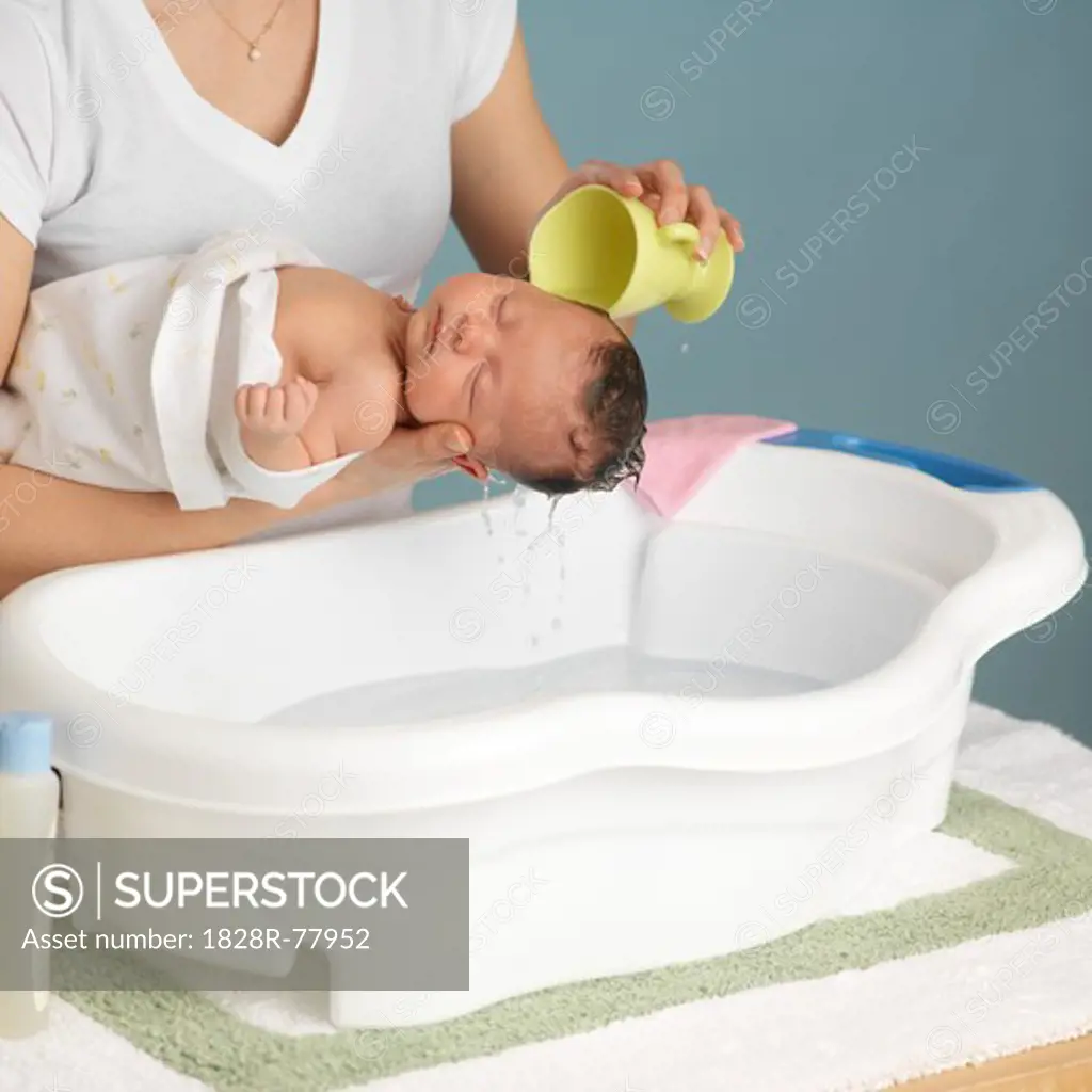 Mother Washing Newborn Baby