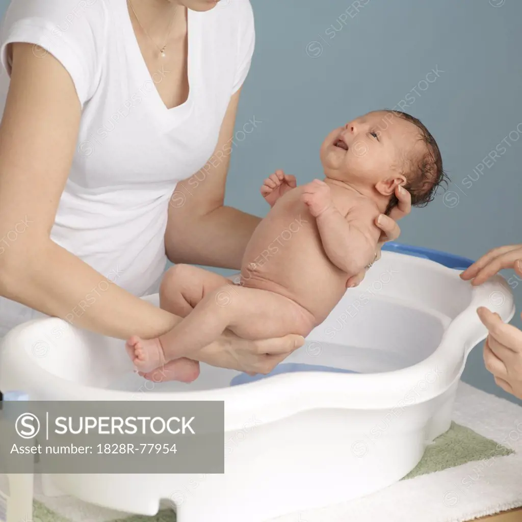 Mother Washing Newborn Baby