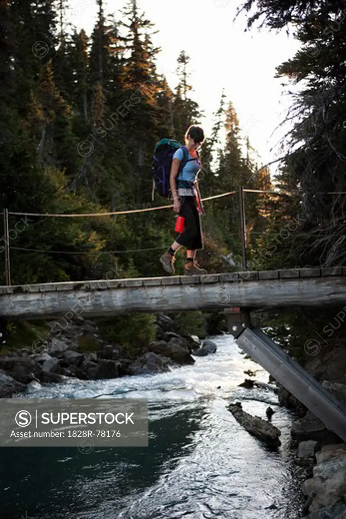 Woman Hiking Across Bridge, Garibaldi Provincial Park, British Columbia, Canada