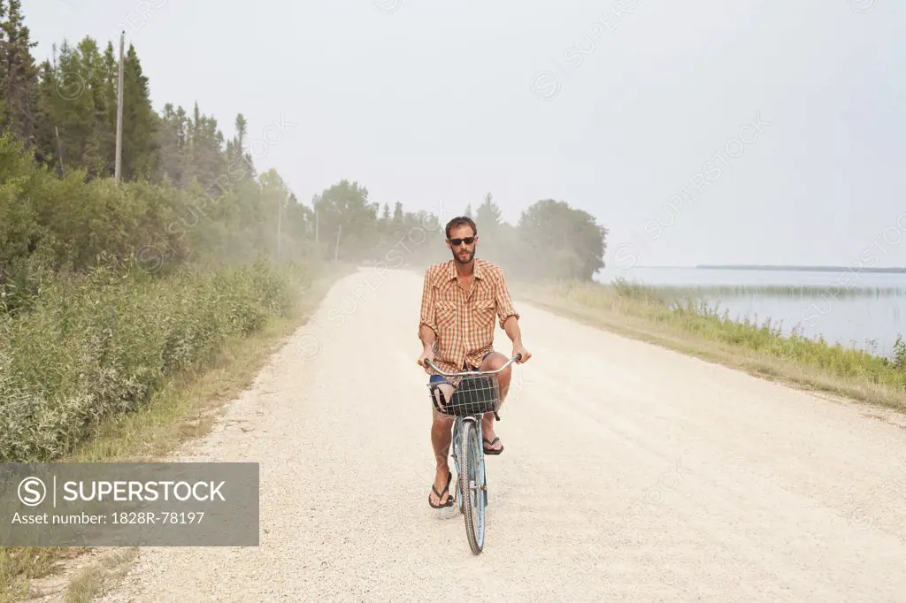 Man Riding Bike, Clearwater Lake Provincial Park, Manitoba, Canada