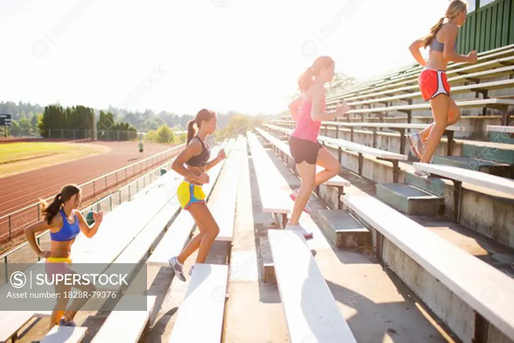 Teenagers Running up Bleachers at Race Track, Lake Oswego, Oregon, USA