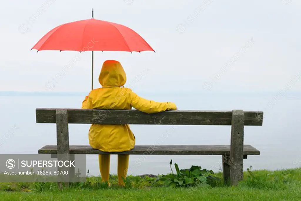 Women sitting on Bench with Umbrella, Lake Chiemsee, Bavaria, Germany