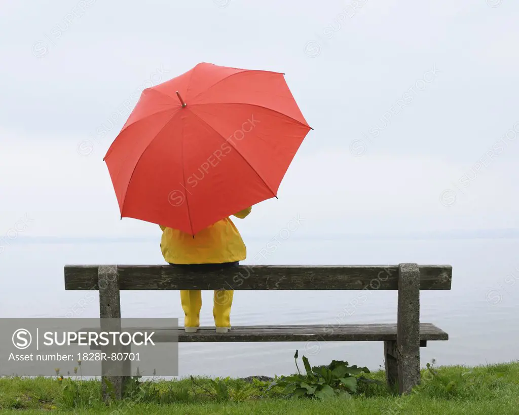 Women sitting on Bench with Umbrella, Lake Chiemsee, Bavaria, Germany