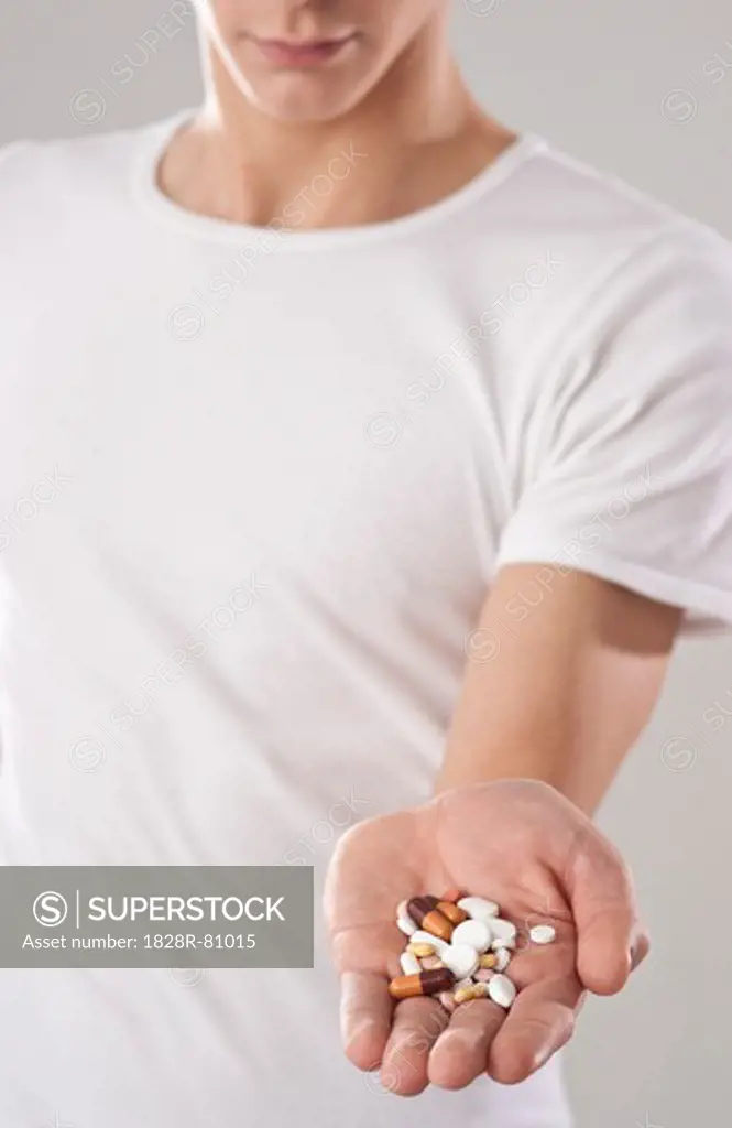 Young Man Holding Pills