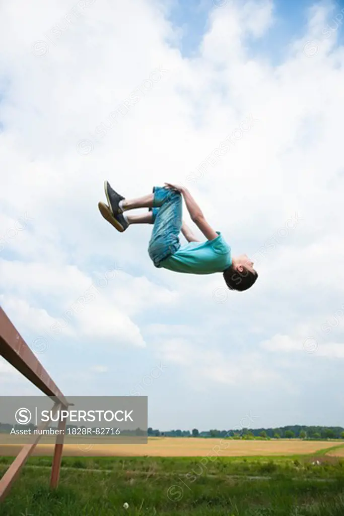 Boy Jumping off Trampoline